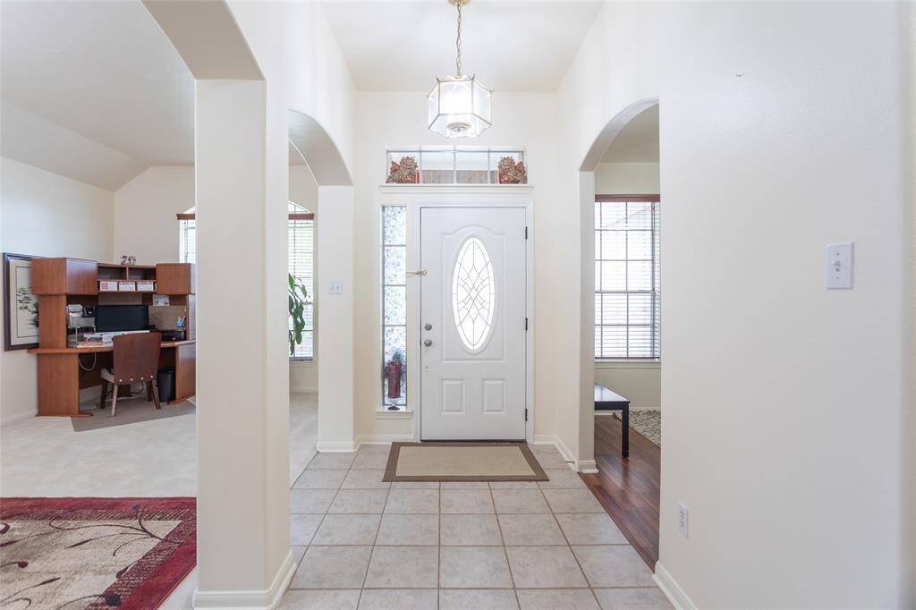View leading to front door, front flex rooms, and secondary, third bedroom / bathroom wing.