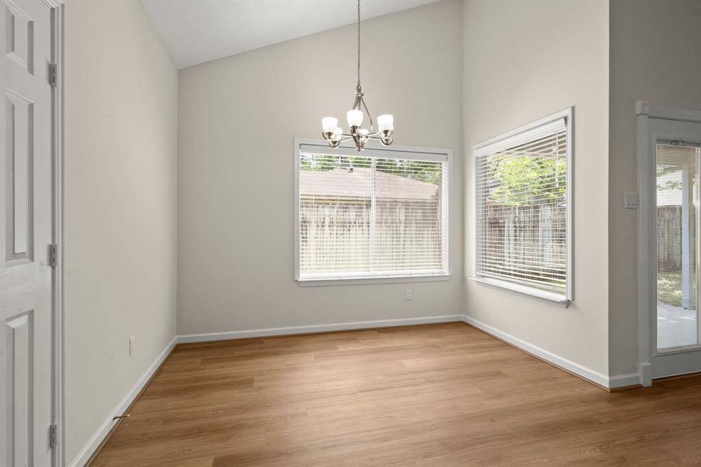 Adjacent to the kitchen, the dining area flows effortlessly into the living space, boasting new light fixtures