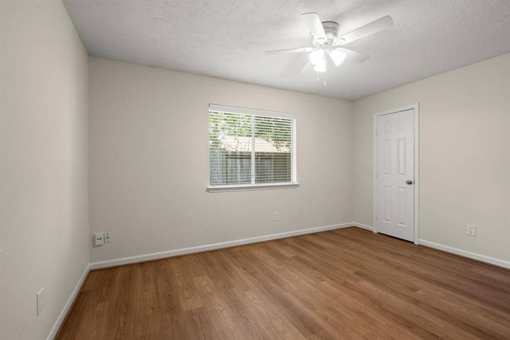 Each secondary bedroom has been fully refreshed with vinyl flooring, fresh paint, ceiling fans, updated lighting, and improved closet functionality.