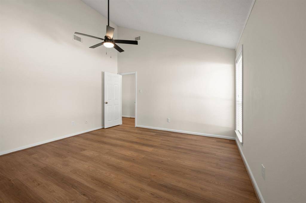 Secondary bedroom, New flooring, fresh paint, ceiling fans, updated lighting, and improved closet functionality.