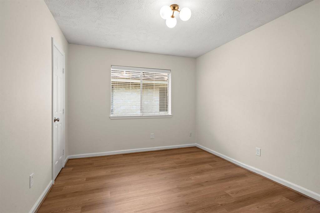 Secondary bedroomvinyl flooring, fresh paint, ceiling fans, updated lighting, and improved closet functionality.