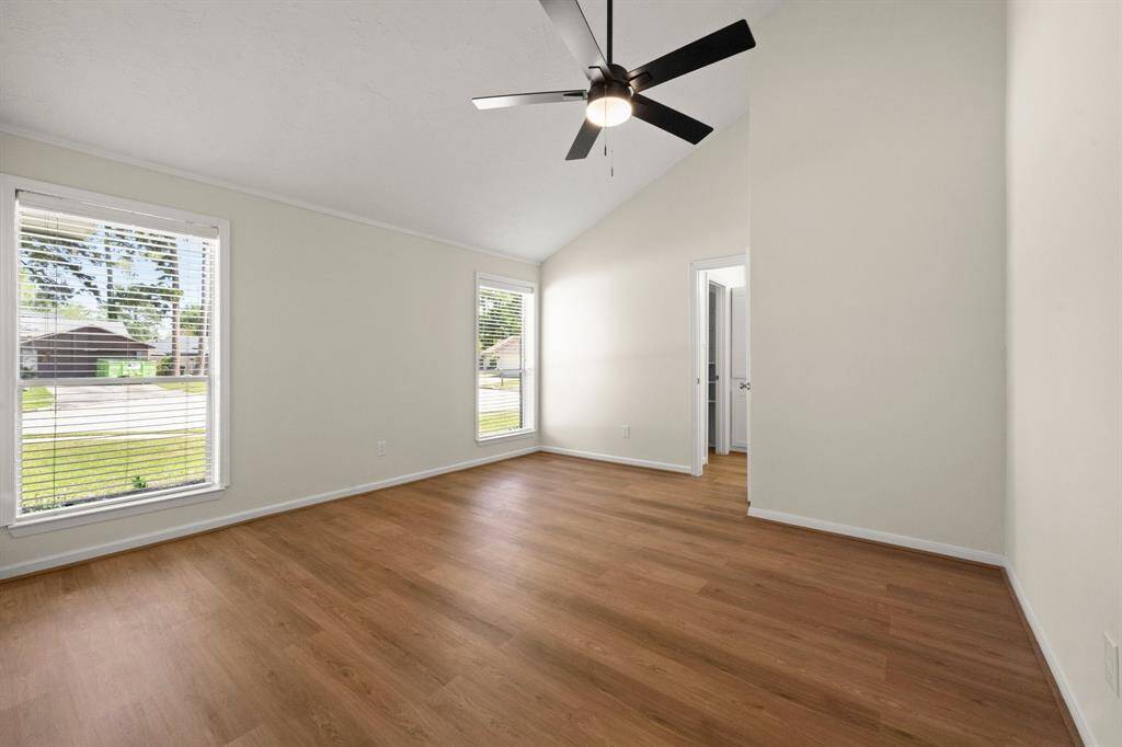 Relax in the spacious primary bedroom with updated lighting, and ceiling fan. A serene space to unwind at the end of the day.