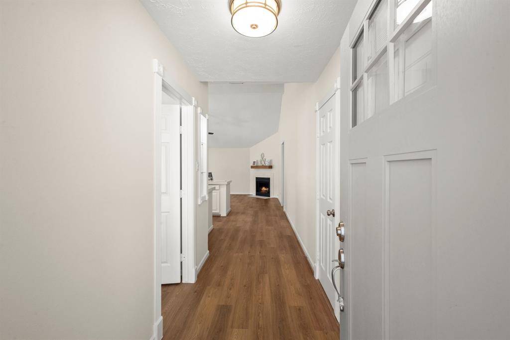 Painted walls, updated fixtures, and sleek vinyl flooring extend into the hallways and utility areas—ensuring continuity and durability throughout
