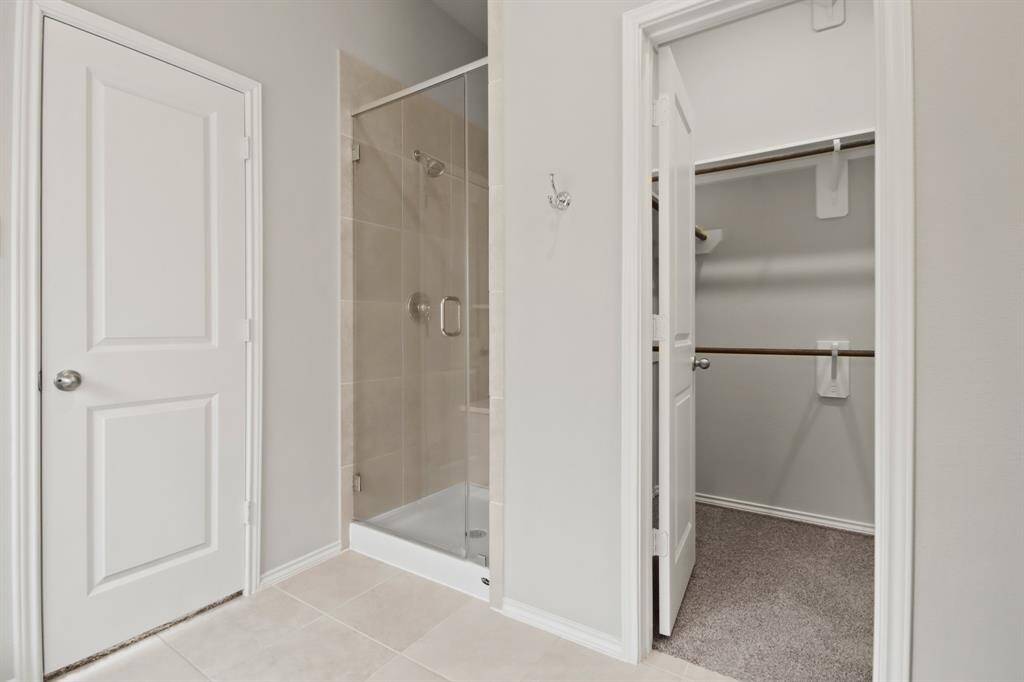 Glass enclosed shower with walk-in closet.  So much natural light!