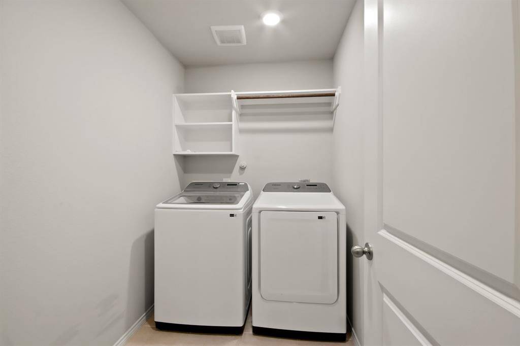 Laundry room with built-ins as you enter from the garage, has recent Samsung washer & dryer included!
