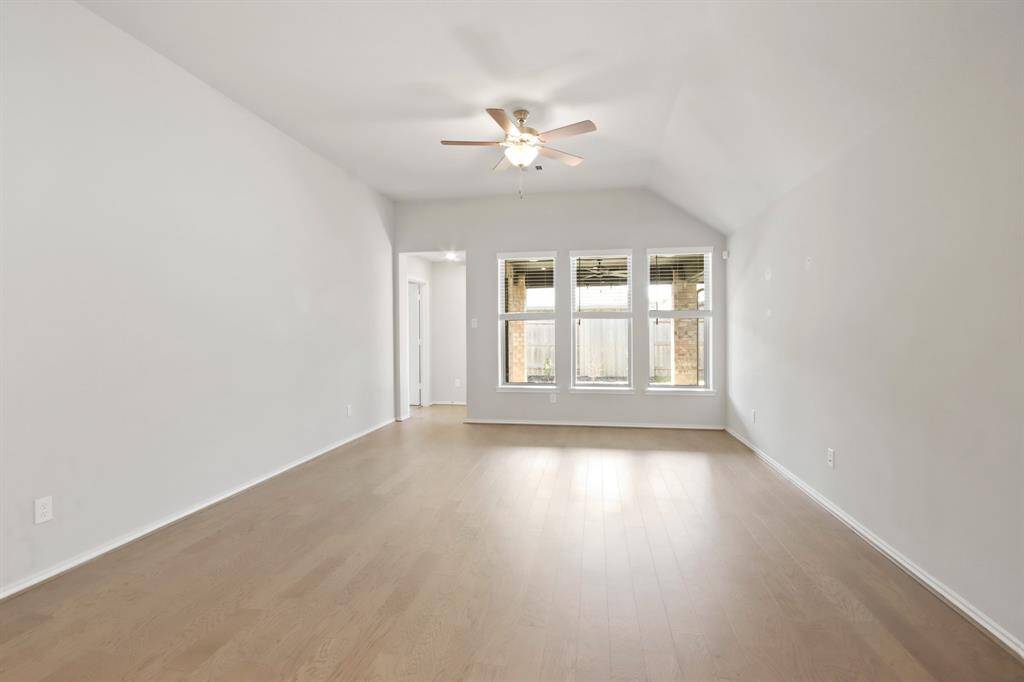 The high ceilings create an open, airy feel that enhances every room! The engineered wood floors add warmth and durability, complementing the neutral color palette throughout the home.