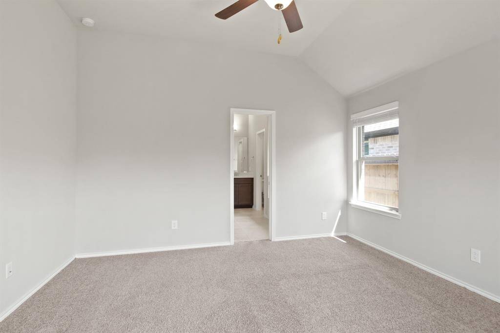 Located at the back of the home, the primary suite is complemented by a grand primary bathroom.  Again, neutral paint, carpet, 2-inch faux wood blinds & ceiling fan!
