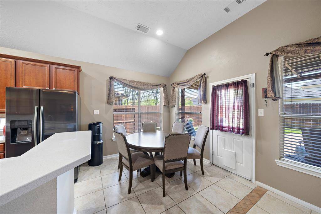 The causal breakfast room is located off the kitchen and features views of the fabulous backyard.