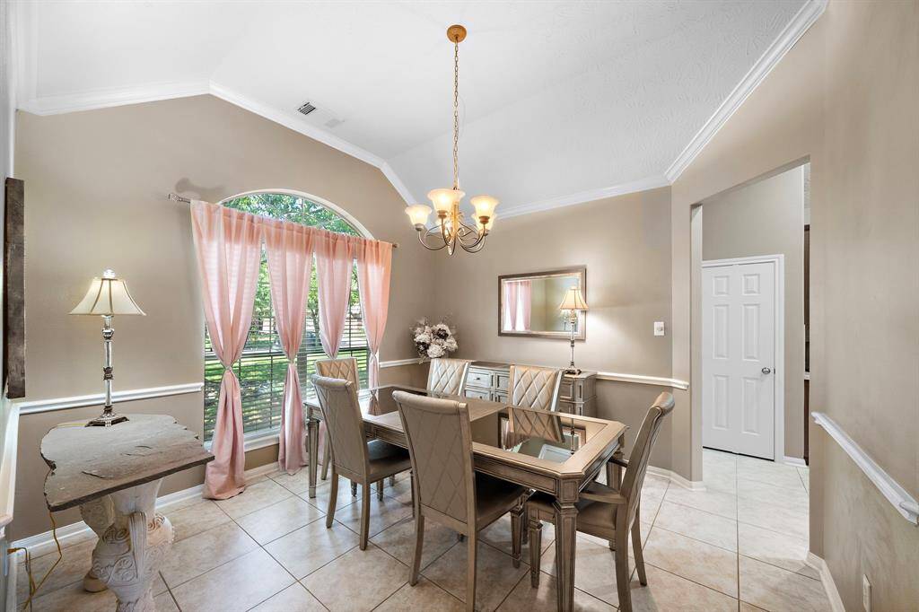 The dining room just off the entry, featuring abundant natural light and the perfect ambiance for hosting everything from holiday dinners to weeknight meals with style.