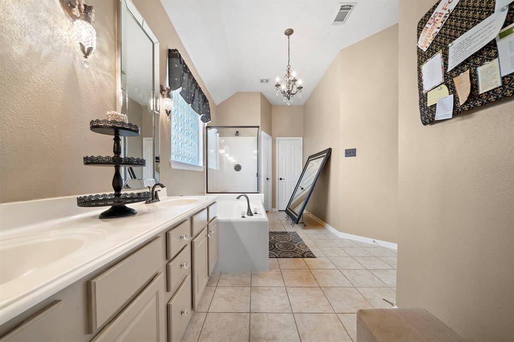 The primary bath offers two vanities, a fabulous closet and a separate soaking tub and standing shower.