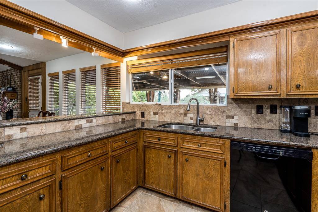 Kitchen sink window opens to the covered patio for serving and pool views.