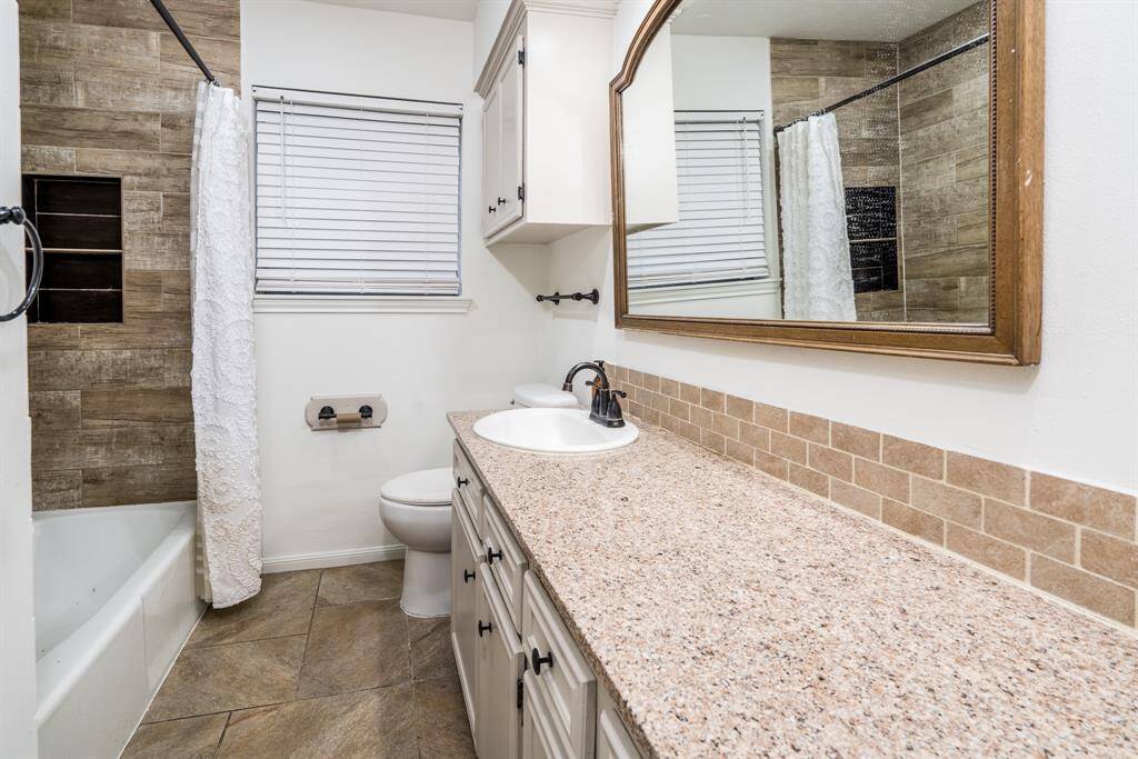 Updated full bath for the secondary bedrooms with granite counter.
