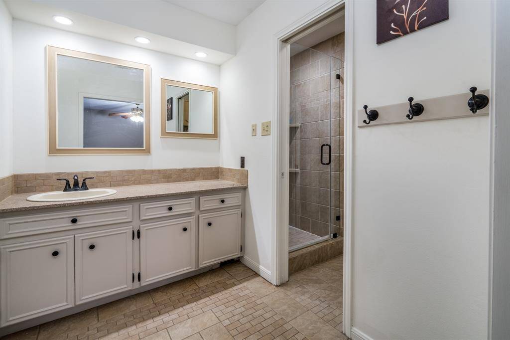 Primary bath with two vanity areas and two closets.