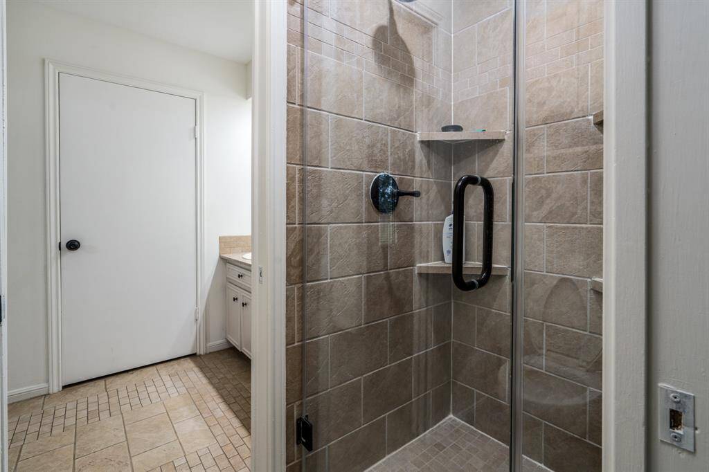 Updated shower with frameless glass.
