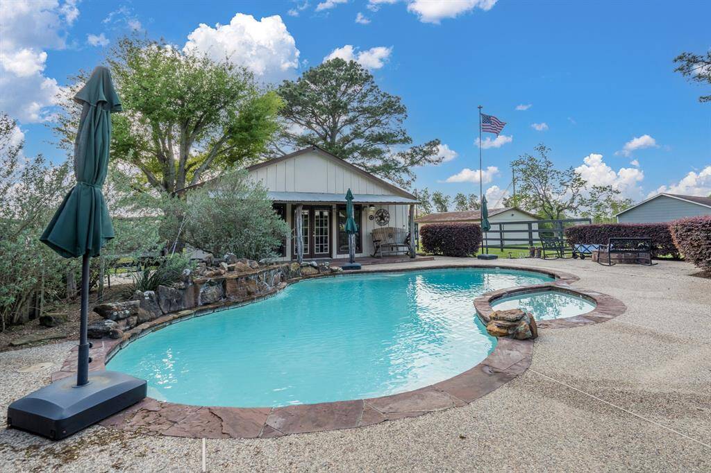 Party patio with pool, spa, pool house and firepit area.