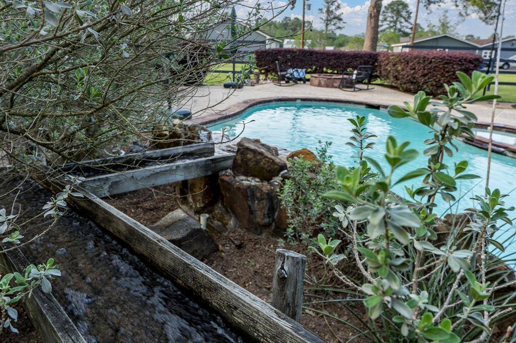 This unique water feature evolves into the waterfall.  Notice the firepit in the background.