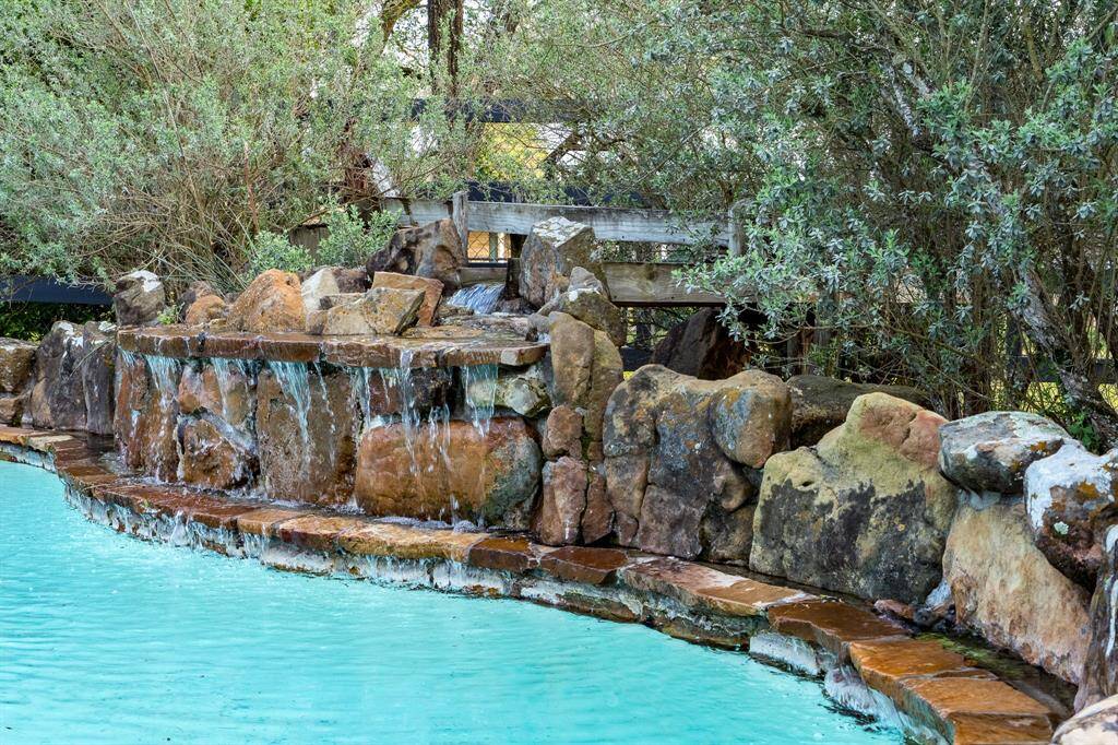 Pool features rock waterfall and pool can be heated.