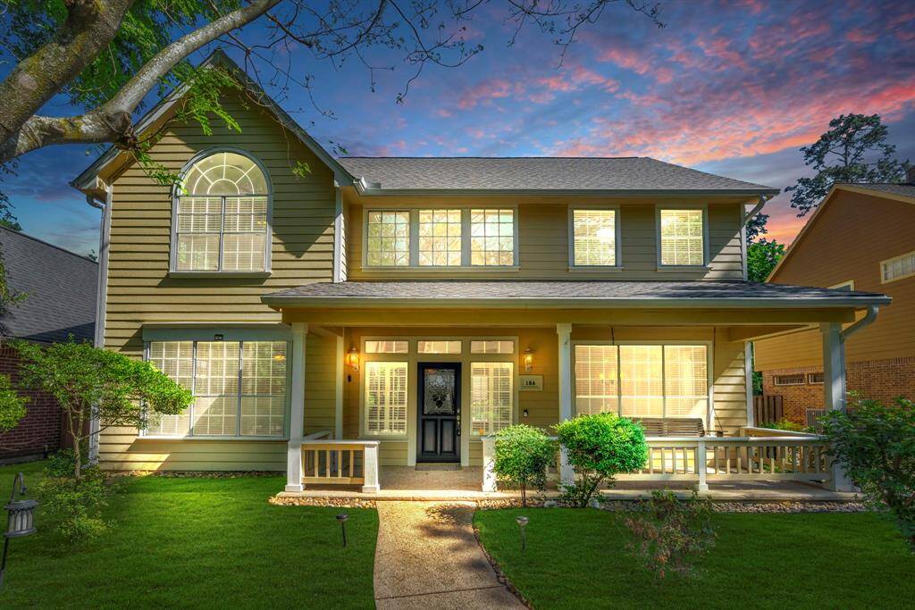 Old-fashioned porch welcomes you to this lovely home in Cochrans Green of The Woodlands