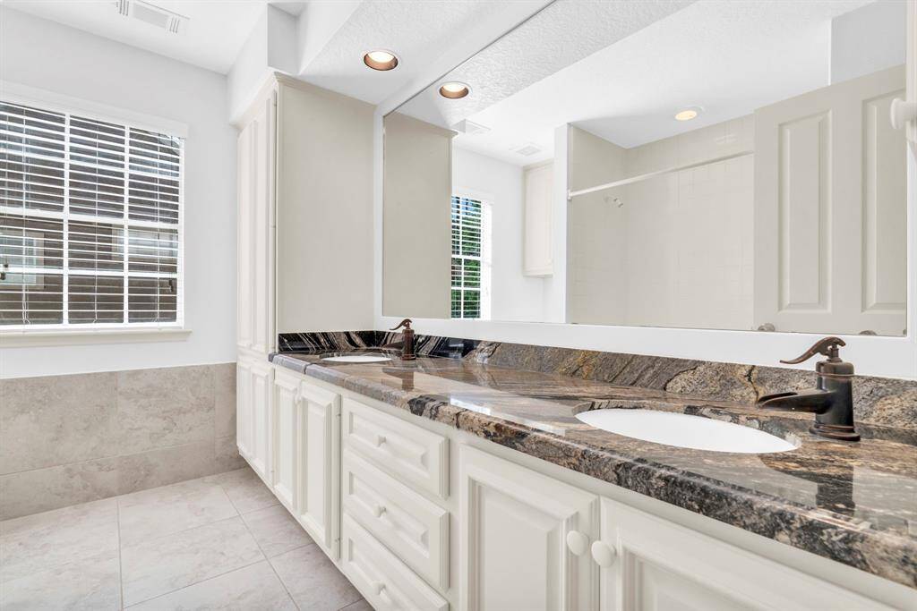 Main upstairs bath with double sinks. Plenty of storage.