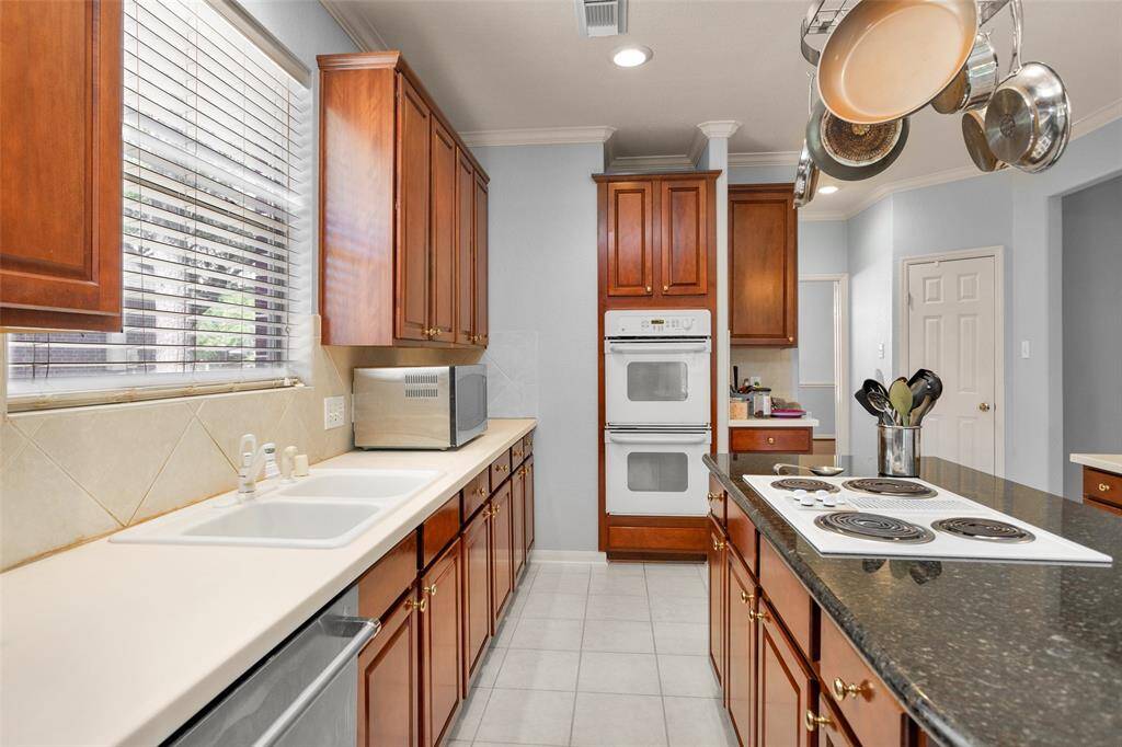 Bright and inviting breakfast area with large windows, providing ample natural light. Features a ceiling fan and easy access to the backyard through a stylish glass door. Perfect for relaxing or entertaining.