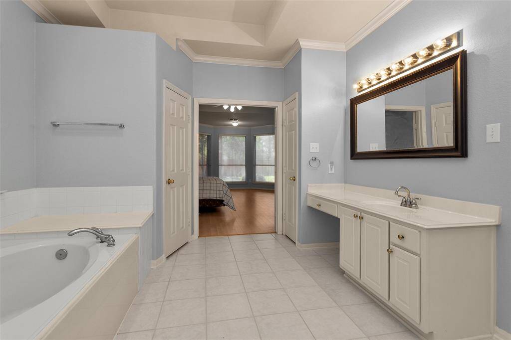 Spacious game room featuring a classic pool table, foosball table, and ample natural light—perfect for entertaining.