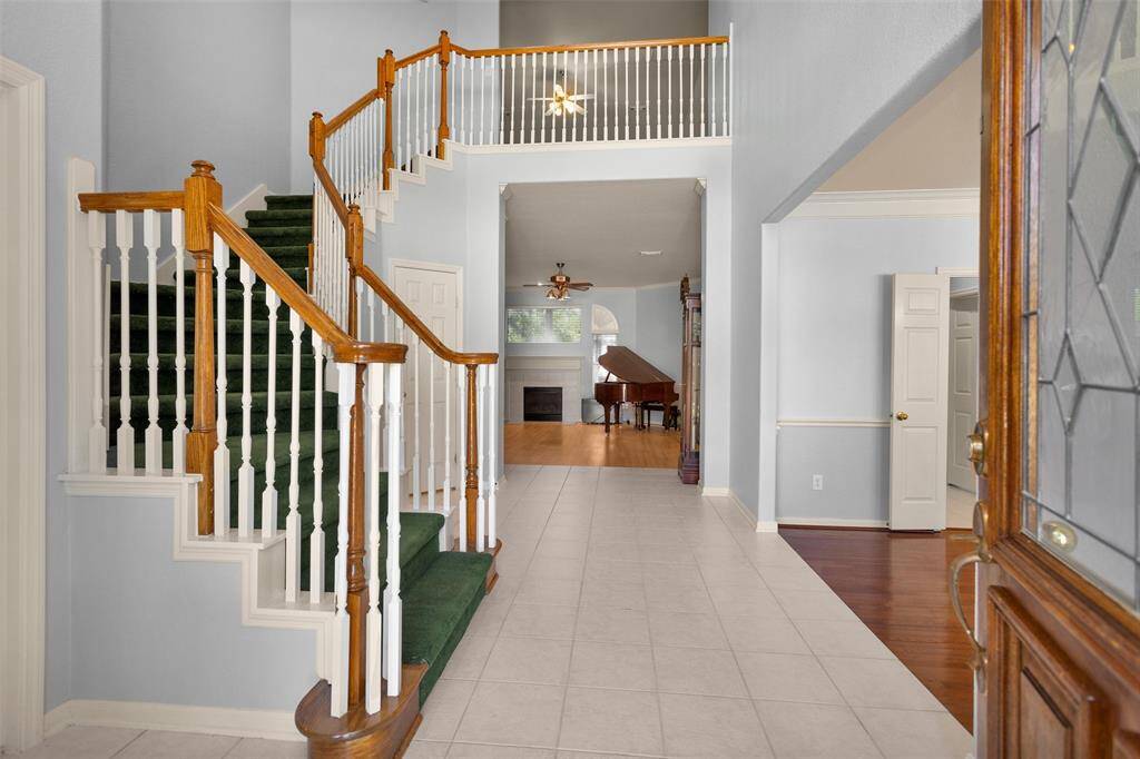 Welcome to your new home! Step into a grand entrance featuring a stunning staircase and elegant tile flooring. The open layout seamlessly connects to a light-filled living area, perfect for both relaxation and entertaining.