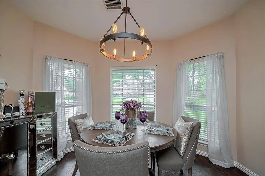 A cozy dining area offering a view of greenery outside