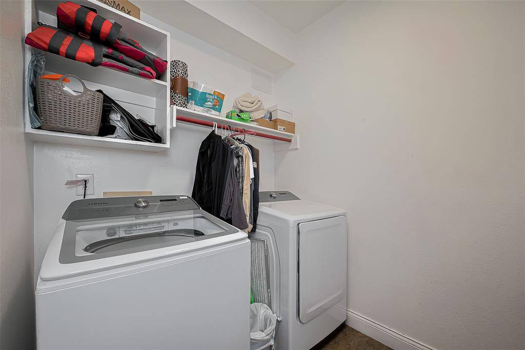The laundry room with open shelving for storage, and a hanging rod for clothes. It's a functional space for household chores.