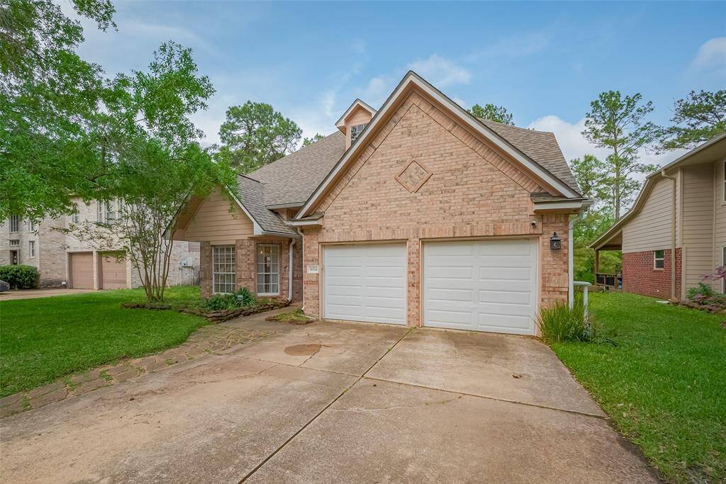 This charming home features a brick facade with a two-car garage and a well-maintained front yard. Located in a peaceful neighborhood, it offers a cozy and inviting exterior with lush greenery and mature trees.