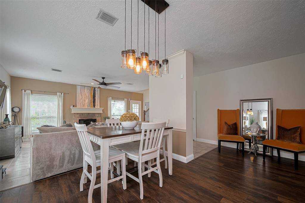 This elegant open-concept living and dining area  Stylish pendant lighting and contemporary furniture add to the inviting atmosphere.