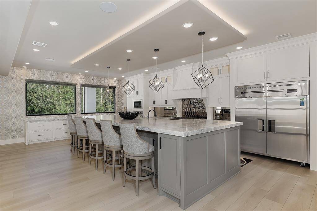 Professional stainless steel appliances, stunning backsplash and ample counter space are all showcased in this main kitchen, while a 2nd catering kitchen can be your main food prep area.