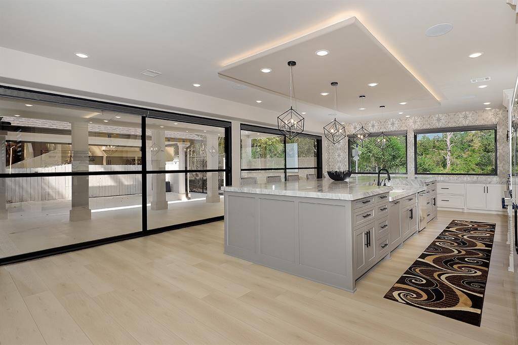 Here's a view of the main kitchen with a wall of windows overlooking the gated porte-cochere.