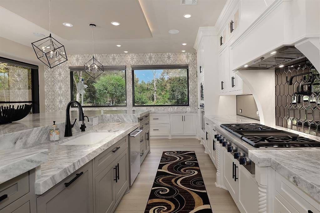 Every aspect of this kitchen radiates elegance and functionality! Being a central part of the home, the beautiful quartzite counters can remain clean, while your catering kitchen does the majority of the work.