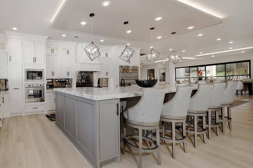 Notice how the kitchen and formal dining converge together seamlessly for entertaining!