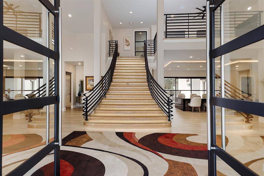 Dual entry doors lead you inside to this impressive foyer with a motion detected light up staircase.