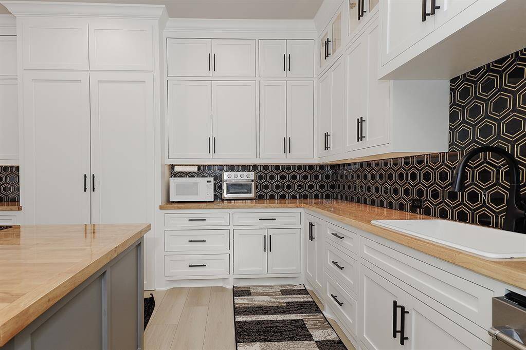 This catering kitchen offers so much storage, prep space, and pull out spice racks.