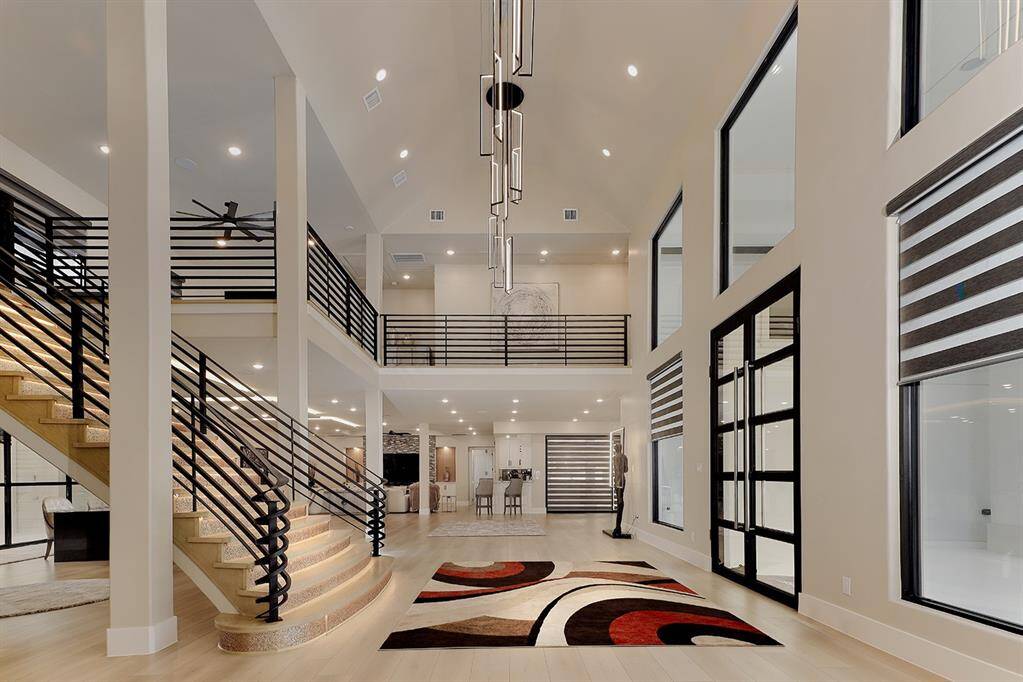 With 23 foot ceilings, motorized shades, designer light fixtures with LED lighting and curated furnishings throughout, this home is the epitome of timeless elegance.