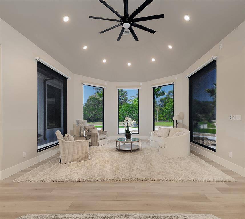 This cozy sitting area is framed in windows with motorized sheer and blackout shades.
