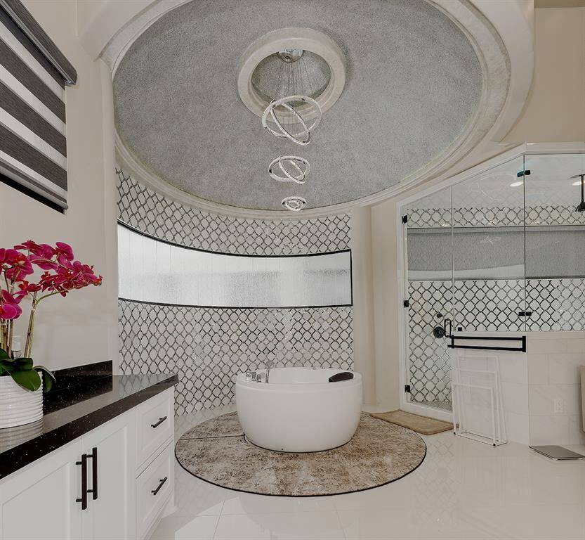 The Japanese soaking tub is the focal point of this stunning bathroom in the owner's retreat.