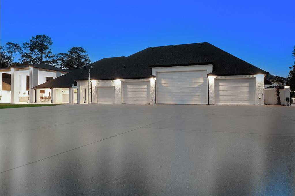 The 18 car garage with polished concrete floors can house two RV's! With varying ceiling heights, this garage can showcase a car collector's fleet.