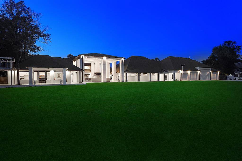 Extensive stained concrete covered patios along the back of the home, with a 25 person wet bar, Trex decking and plenty of space to add a pool or pond!
