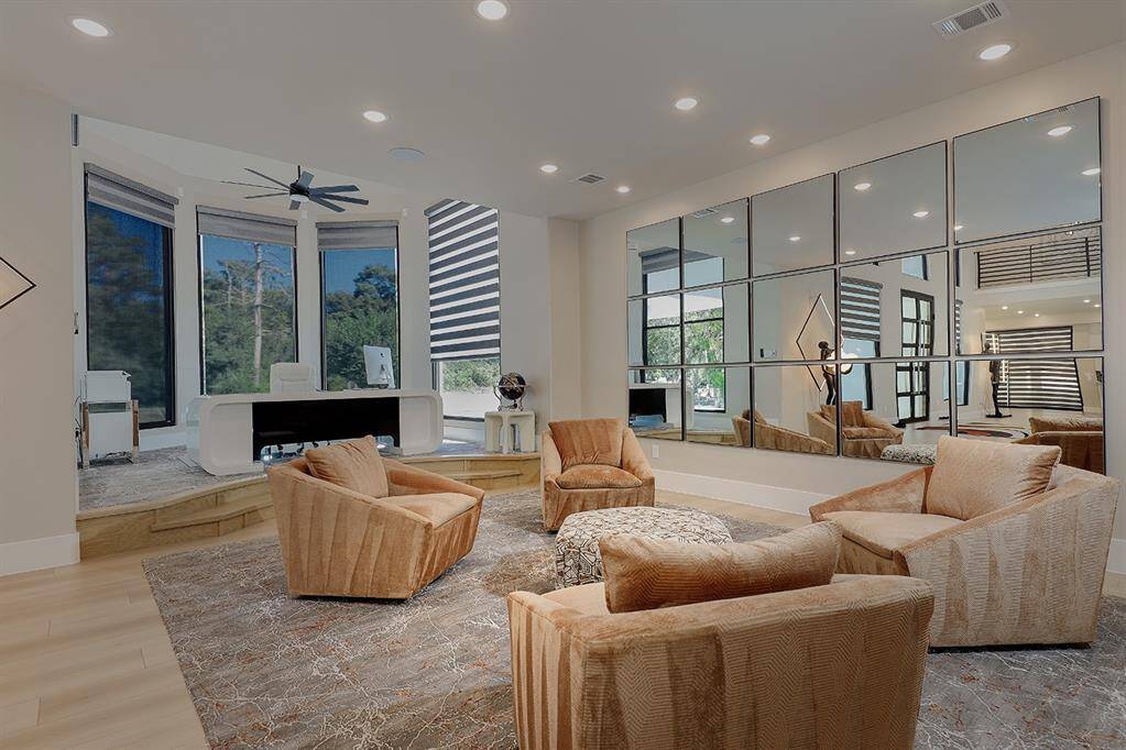 These two living spaces are bathed in natural light from the large windows framing the front of the home.