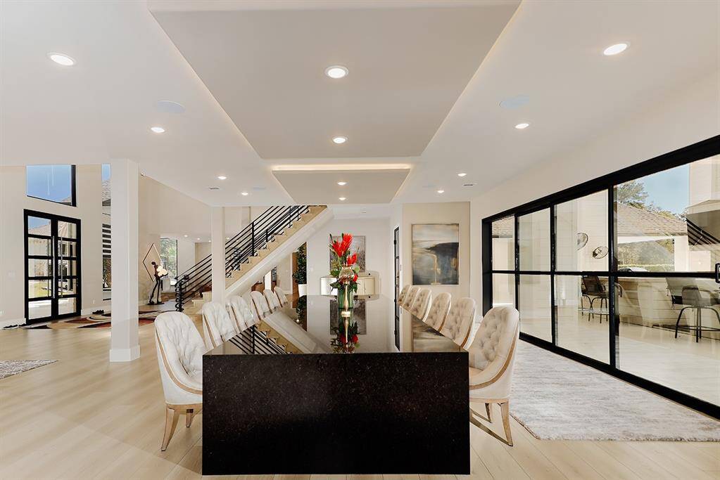 The open concept formal dining with an adjacent bar makes for flawless entertaining.