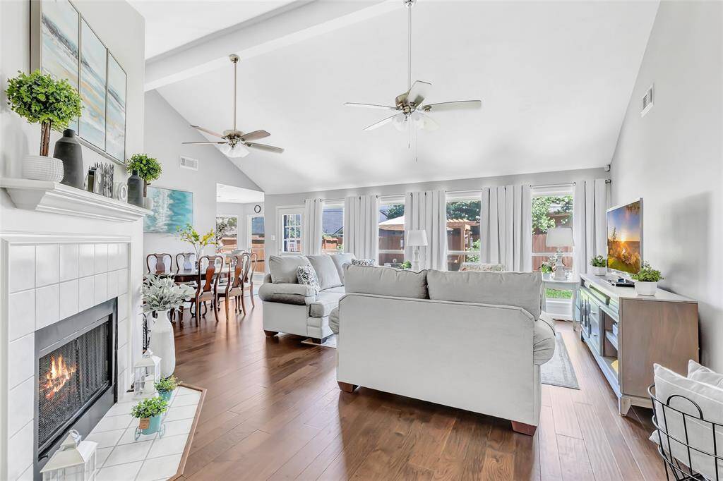 The living room and dining room are full of natural light and feature a gas fireplace.