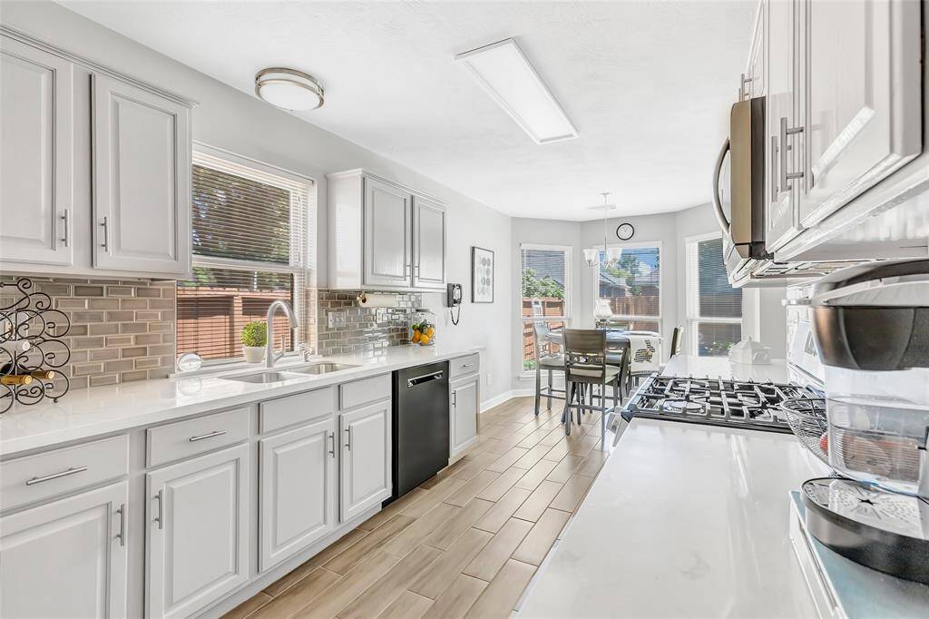 The kitchen with plenty of countertop space and the breakfast room.