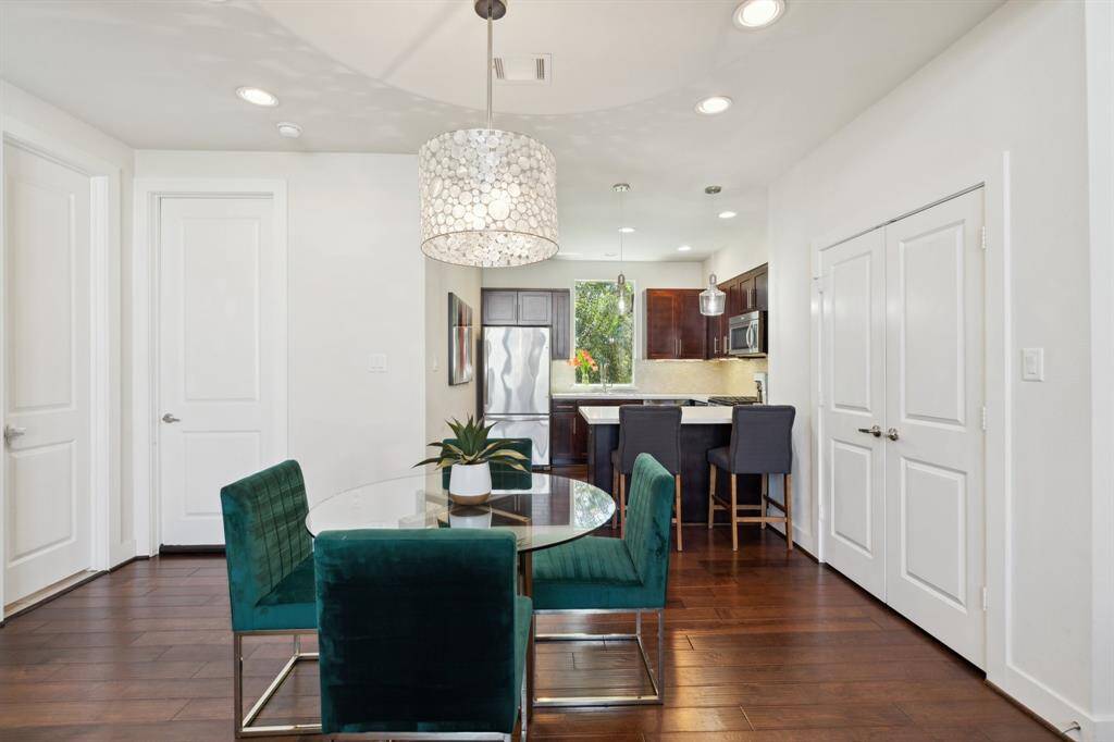 Beautiful hardwood cabinets and stainless steel appliances. Notice lots of extra lighting in this kitchen with countertop dining.