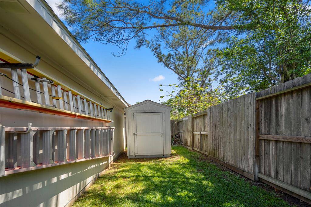 Shed and green space behind garage