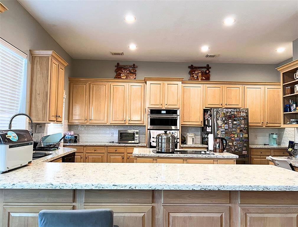 This butler’s pantry equipped with an abundant cabinets and drawers and quartz countertops.