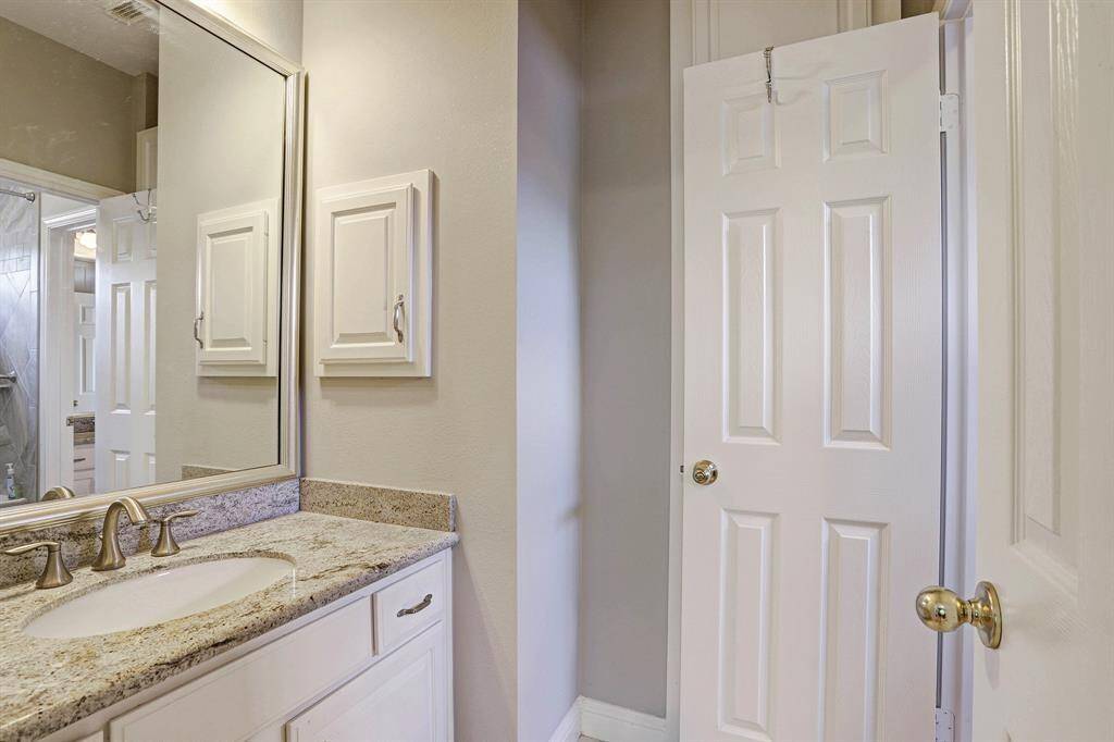 Jack and Jill bathroom includes an updated granite counter top, faucet, built-in medicine cabinet and generous storage space.