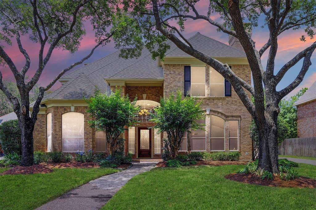 Spacious entryway boasts crown molding, a new chandelier, an abundance of natural light and gorgeous hardwood floors